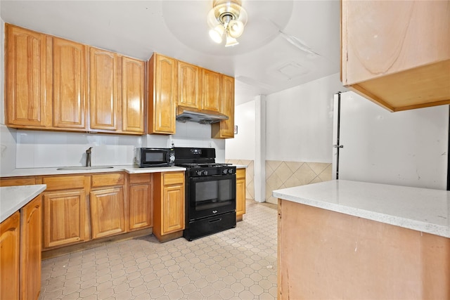 41-20 Elbertson St, Elmhurst, NY 11373 - kitchen with black appliances, a sink, under cabinet range hood, light countertops, and a ceiling fan