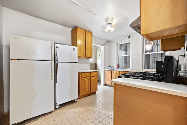41-20 Elbertson St, Elmhurst, NY 11373 - kitchen featuring freestanding refrigerator, light countertops, stove, and light flooring