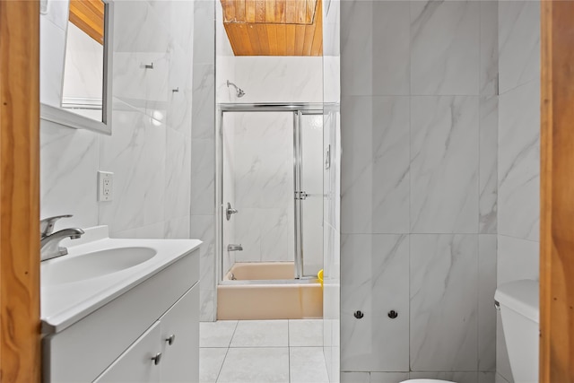 41-20 Elbertson St, Elmhurst, NY 11373 - full bathroom featuring tile walls, vanity, toilet, enclosed tub / shower combo, and tile patterned flooring