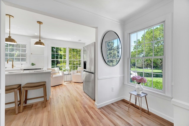 2850 Reeve Rd, Mattituck, NY 11952 - kitchen with stainless steel fridge with ice dispenser, plenty of natural light, and ornamental molding