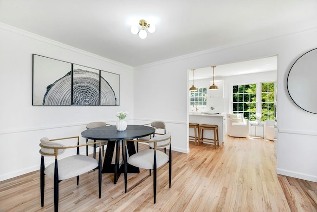 2850 Reeve Rd, Mattituck, NY 11952 - dining space featuring light wood-type flooring and ornamental molding