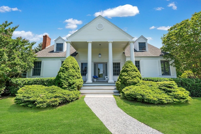 2850 Reeve Rd, Mattituck, NY 11952 - greek revival inspired property featuring roof with shingles, a chimney, and a front lawn