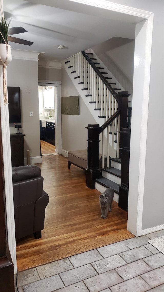 1026 Logan Ave, Bronx, NY 10465 - staircase with baseboards, crown molding, stone tile flooring, and a ceiling fan
