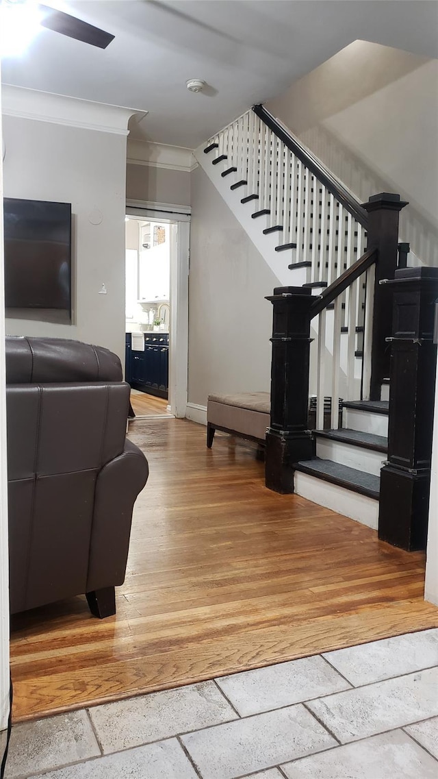 1026 Logan Ave, Bronx, NY 10465 - stairs with crown molding, baseboards, and stone tile flooring