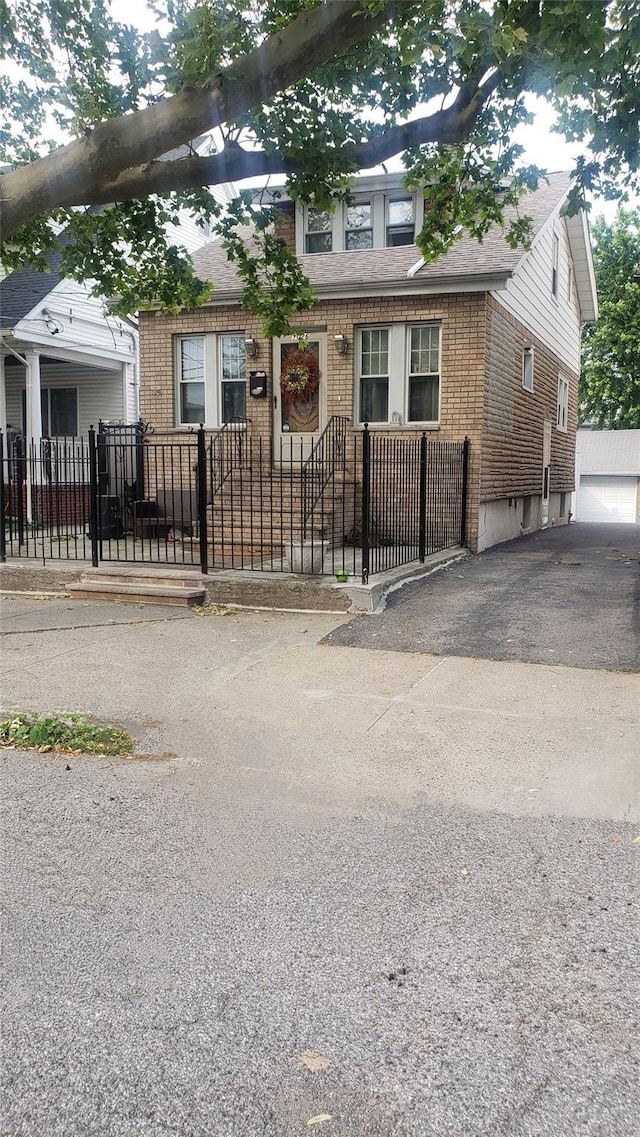 1026 Logan Ave, Bronx, NY 10465 - view of front of home featuring brick siding, a fenced front yard, and a shingled roof