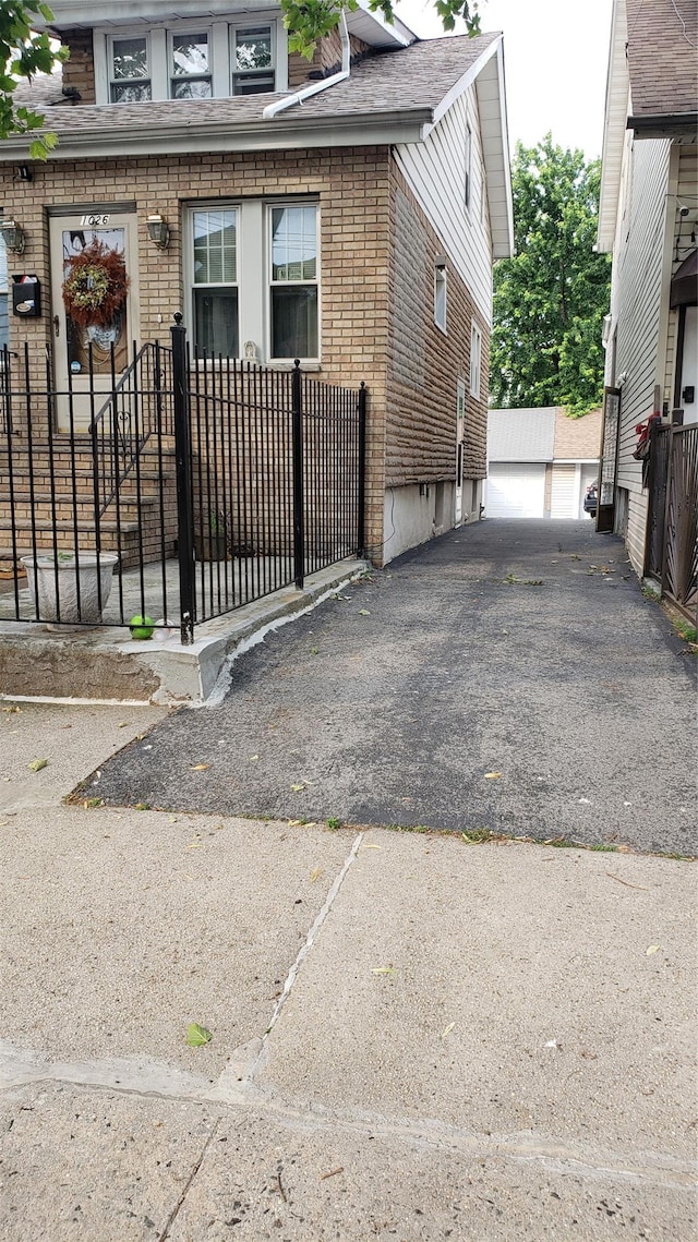 1026 Logan Ave, Bronx, NY 10465 - view of front of house featuring brick siding and roof with shingles