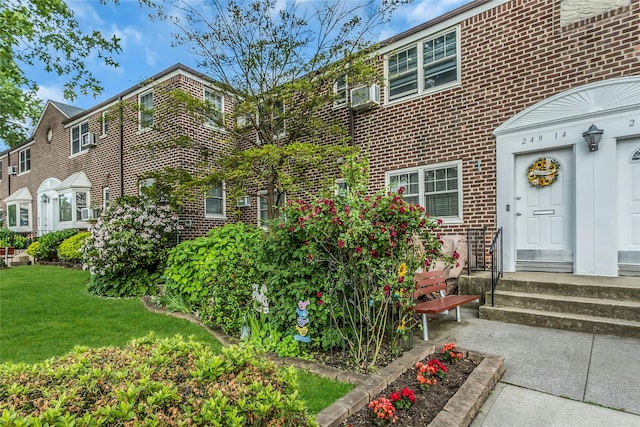 249-14 57th Ave Unit 259, Little Neck, NY 11362 - entrance to property featuring brick siding and a lawn