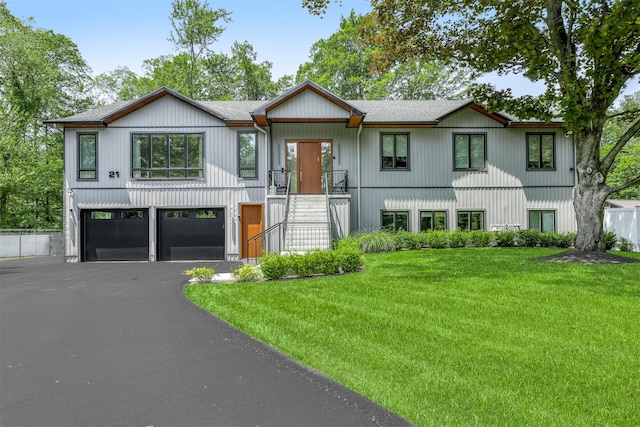 21 Dale Rd, Monsey, NY 10952 - modern farmhouse featuring a garage, asphalt driveway, a front lawn, and roof with shingles