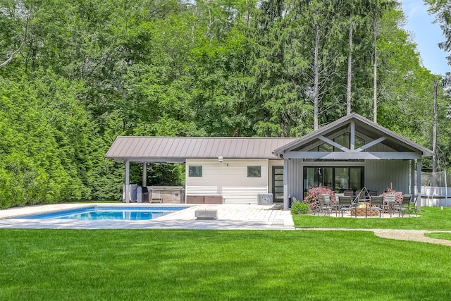21 Dale Rd, Monsey, NY 10952 - back of property with a hot tub, a patio area, a lawn, and metal roof