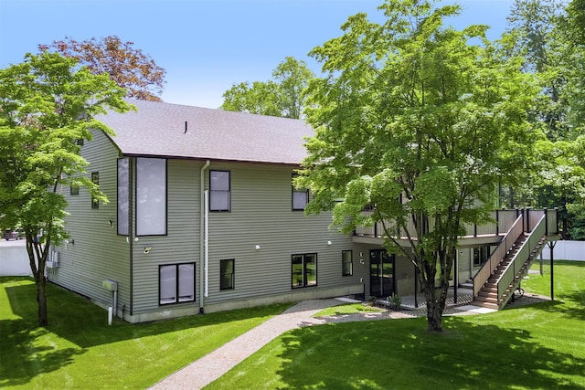 21 Dale Rd, Monsey, NY 10952 - back of house with roof with shingles, a yard, and stairs