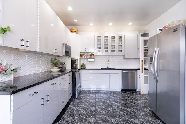 786 N Broadway, Yonkers, NY 10701 - kitchen with appliances with stainless steel finishes, a sink, tasteful backsplash, dark countertops, and white cabinets