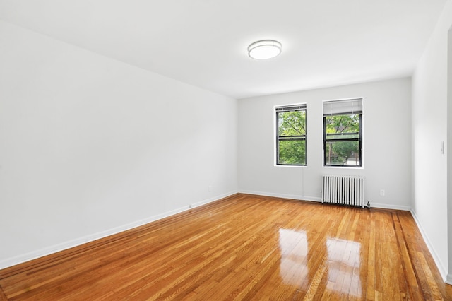 312 Main St Unit 4F, White Plains, NY 10601 - unfurnished room featuring radiator and light wood-type flooring