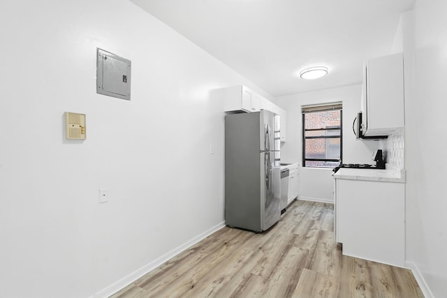 312 Main St Unit 4F, White Plains, NY 10601 - kitchen featuring freestanding refrigerator, electric panel, light wood finished floors, range, and light countertops