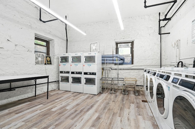 312 Main St Unit 4F, White Plains, NY 10601 - community laundry featuring independent washer and dryer, wood finished floors, stacked washer / drying machine, and a high ceiling