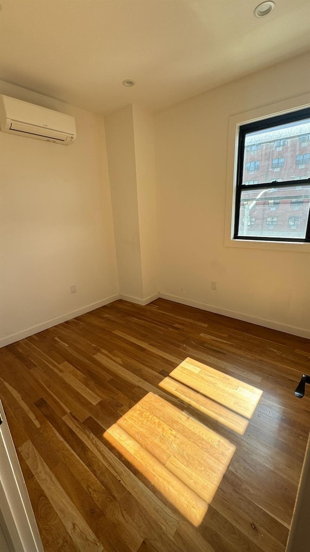 31 Roosevelt Pl, Brooklyn, NY 11233 - spare room featuring a wall mounted AC, wood finished floors, and recessed lighting