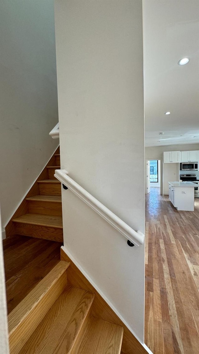 31 Roosevelt Pl, Brooklyn, NY 11233 - stairs featuring wood finished floors and recessed lighting