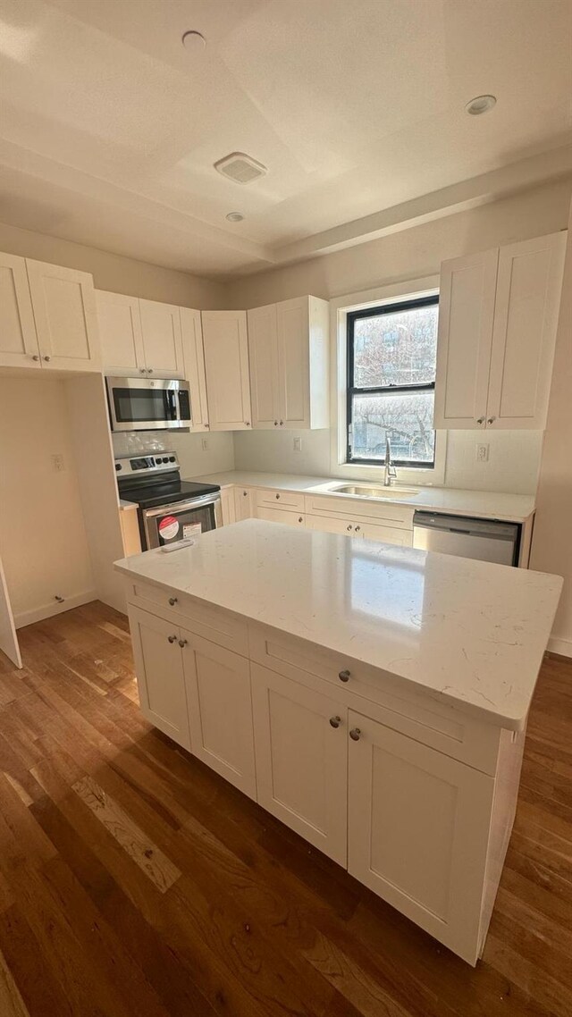 31 Roosevelt Pl, Brooklyn, NY 11233 - kitchen featuring appliances with stainless steel finishes, white cabinets, and recessed lighting
