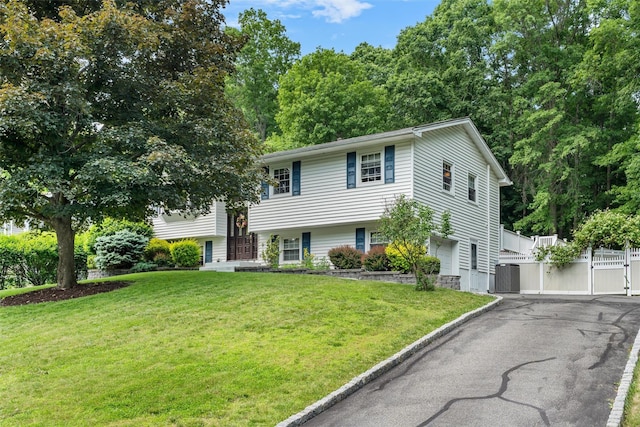 154 Meadow Lark Rd, Montgomery, NY 12549 - view of front of home featuring a gate, asphalt driveway, central AC unit, and a garage