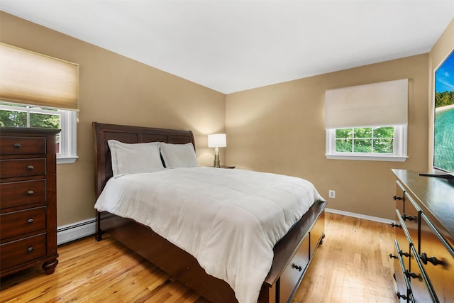 154 Meadow Lark Rd, Montgomery, NY 12549 - bedroom with a baseboard radiator, light wood-style floors, and baseboards