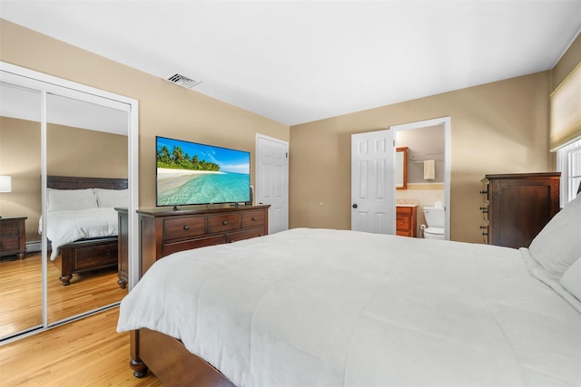 154 Meadow Lark Rd, Montgomery, NY 12549 - bedroom featuring wood finished floors, a baseboard radiator, and ensuite bath