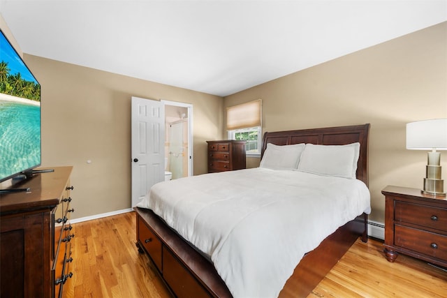 154 Meadow Lark Rd, Montgomery, NY 12549 - bedroom featuring light wood-style flooring, baseboards, baseboard heating, and connected bathroom