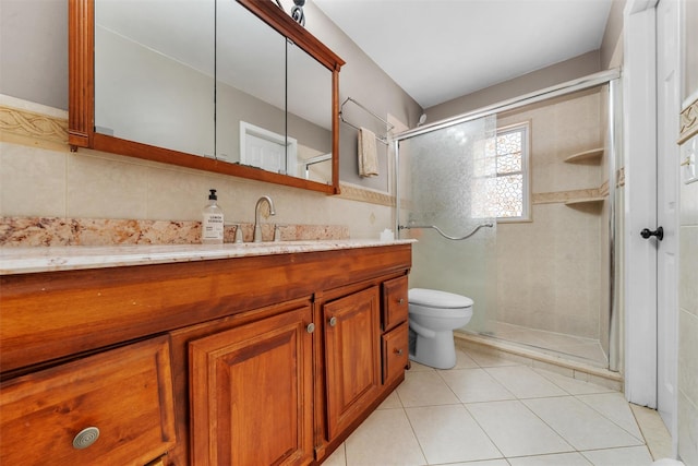154 Meadow Lark Rd, Montgomery, NY 12549 - full bathroom with a stall shower, vanity, toilet, tile patterned floors, and tile walls