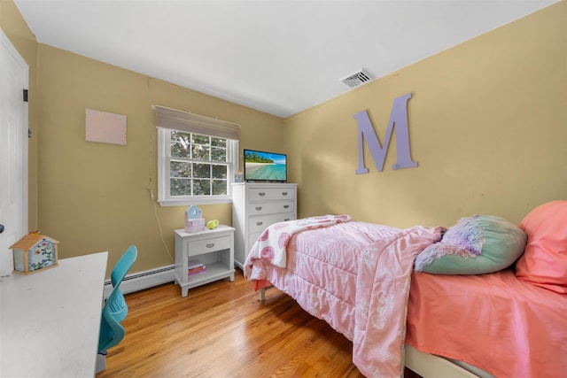 154 Meadow Lark Rd, Montgomery, NY 12549 - bedroom featuring wood finished floors and a baseboard radiator