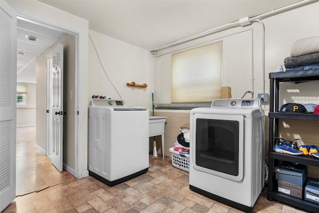 154 Meadow Lark Rd, Montgomery, NY 12549 - washroom with separate washer and dryer, light stone finish floors, and baseboards
