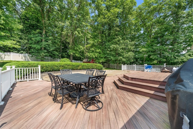 154 Meadow Lark Rd, Montgomery, NY 12549 - wooden deck with outdoor dining area, a fenced backyard, and view of wooded area