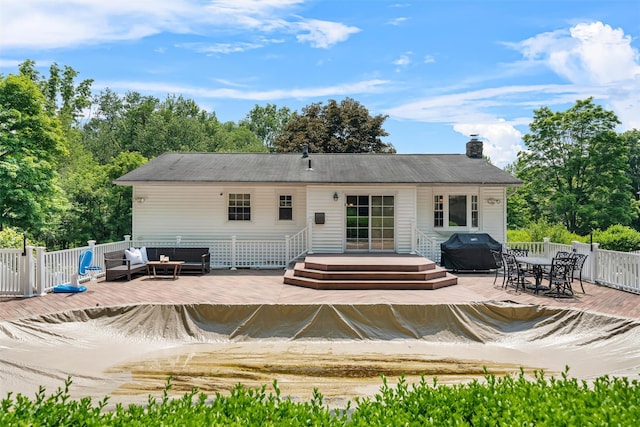 154 Meadow Lark Rd, Montgomery, NY 12549 - rear view of house with a wooden deck, outdoor dining space, a chimney, and view of scattered trees