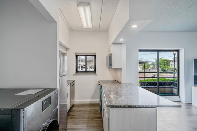 725 Miller Ave Unit 134, Freeport, NY 11520 - kitchen featuring appliances with stainless steel finishes, white cabinetry, baseboards, dark wood finished floors, and plenty of natural light