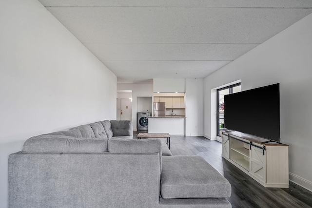 725 Miller Ave Unit 134, Freeport, NY 11520 - living room featuring washer / dryer, dark wood-style floors, and baseboards