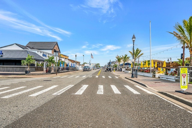 725 Miller Ave Unit 134, Freeport, NY 11520 - view of asphalt street featuring curbs, sidewalks, street lights, and traffic signs