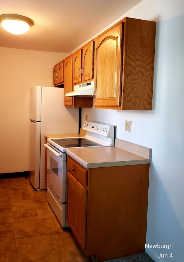 20 Pierces Rd Unit 61, Newburgh, NY 12550 - kitchen featuring white electric range oven, under cabinet range hood, light countertops, and brown cabinets