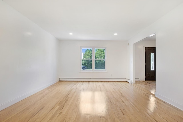 16 Sampson Ave, Islandia, NY 11749 - spare room featuring a baseboard heating unit, light wood finished floors, baseboards, and recessed lighting