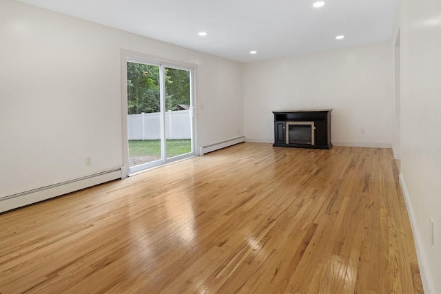 16 Sampson Ave, Islandia, NY 11749 - unfurnished living room featuring a baseboard heating unit, light wood-style flooring, recessed lighting, a fireplace, and baseboards