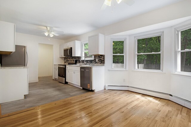 16 Sampson Ave, Islandia, NY 11749 - kitchen with appliances with stainless steel finishes, a ceiling fan, light wood-type flooring, and light countertops