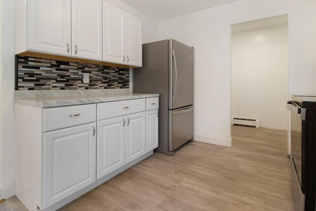 16 Sampson Ave, Islandia, NY 11749 - kitchen with a baseboard radiator, white cabinets, electric stove, freestanding refrigerator, and backsplash