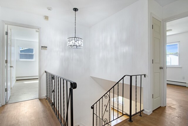 16 Sampson Ave, Islandia, NY 11749 - stairway with a baseboard radiator, wood finished floors, and a chandelier