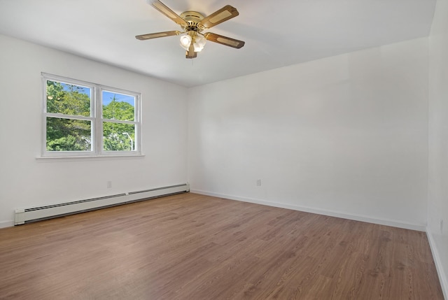 16 Sampson Ave, Islandia, NY 11749 - unfurnished room with baseboard heating, wood finished floors, a ceiling fan, and baseboards