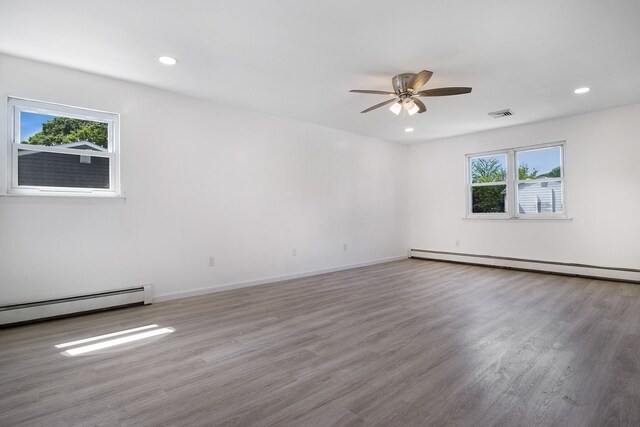 16 Sampson Ave, Islandia, NY 11749 - empty room featuring baseboard heating, a ceiling fan, wood finished floors, and recessed lighting