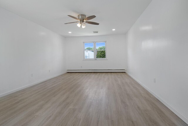 16 Sampson Ave, Islandia, NY 11749 - spare room featuring baseboard heating, ceiling fan, light wood finished floors, baseboards, and recessed lighting