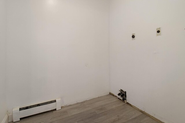 16 Sampson Ave, Islandia, NY 11749 - washroom featuring hookup for an electric dryer, baseboard heating, and light wood-type flooring