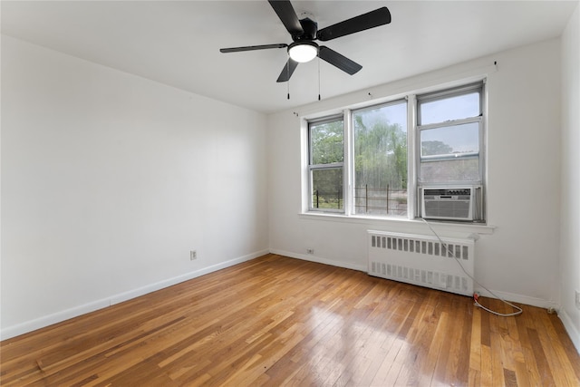 300 N Broadway Unit 7B, Yonkers, NY 10710 - empty room featuring radiator, cooling unit, light wood-type flooring, and a ceiling fan