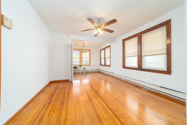 124-01 9th Ave, College Point, NY 11356 - empty room featuring a ceiling fan, light wood finished floors, baseboards, a baseboard heating unit, and a baseboard radiator