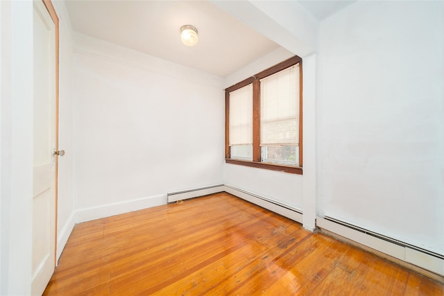 124-01 9th Ave, College Point, NY 11356 - unfurnished room with baseboard heating and light wood finished floors
