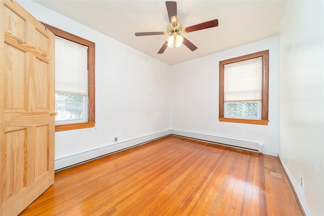 124-01 9th Ave, College Point, NY 11356 - empty room with hardwood / wood-style flooring, healthy amount of natural light, baseboard heating, and a ceiling fan