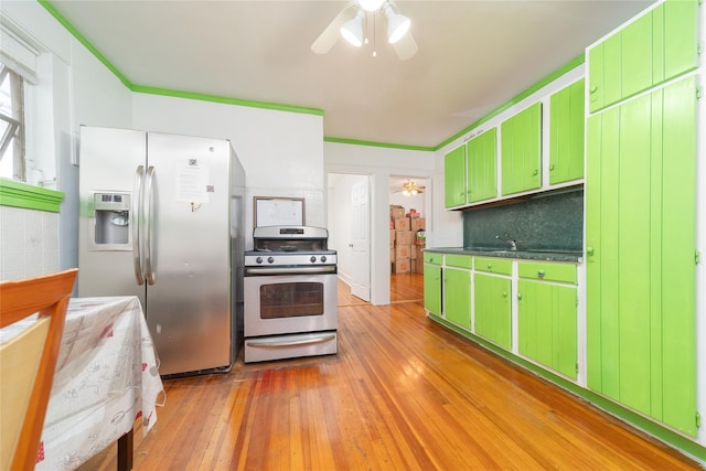 124-01 9th Ave, College Point, NY 11356 - kitchen featuring appliances with stainless steel finishes, green cabinets, ceiling fan, and light wood-style flooring