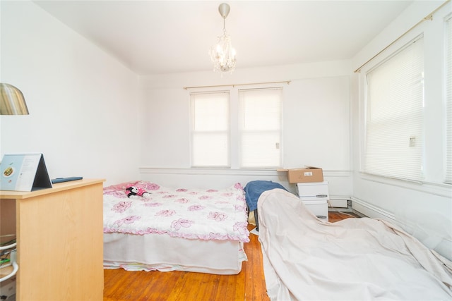 124-01 9th Ave, College Point, NY 11356 - bedroom with a chandelier and wood finished floors