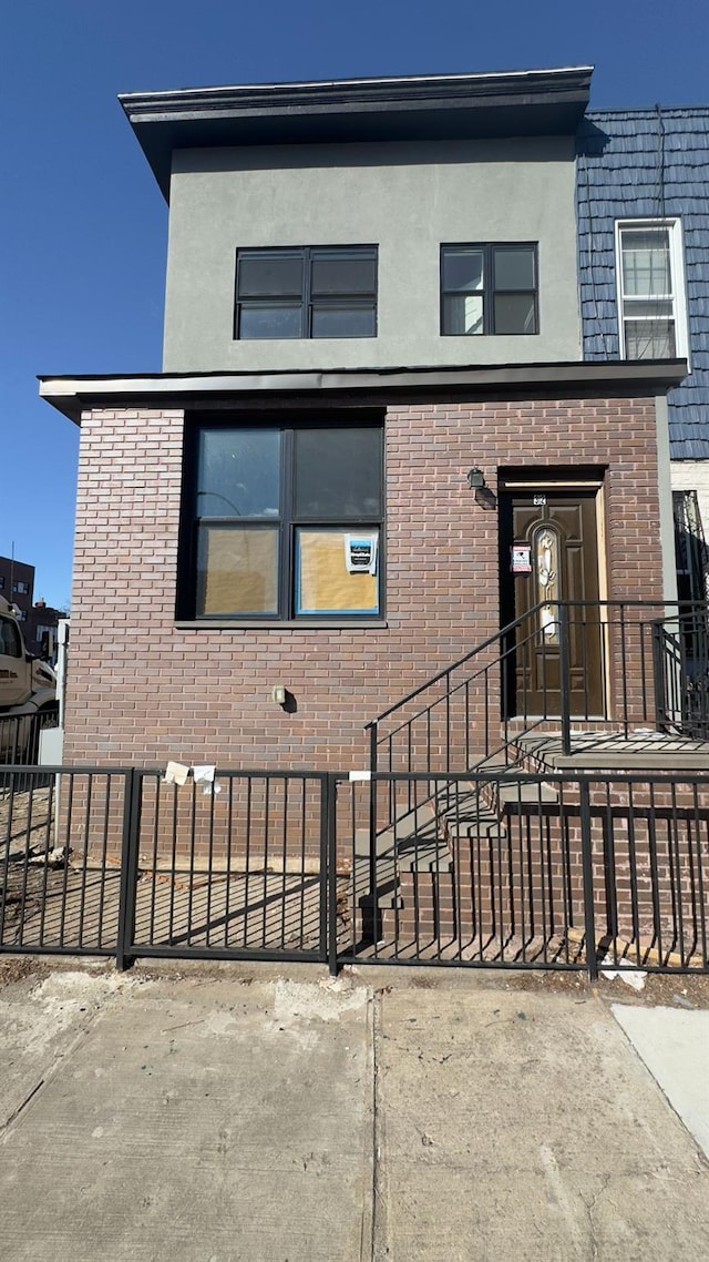 32 Radde Pl, Brooklyn, NY 11233 - view of front of house featuring brick siding and stucco siding